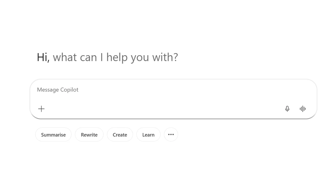 Microsoft 365 Copilot Chat empty-state home with the message composer — the microphone icon and audio-waveform icon on the right of the prompt box are the voice-chat entry points for hands-free conversations.